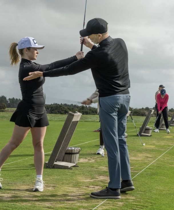 Paul Parlane coaching a student on the driving range
