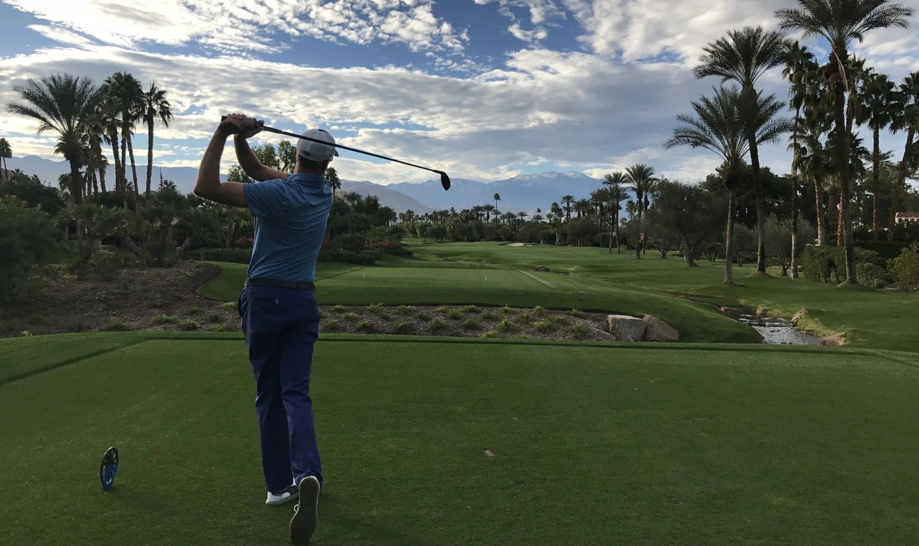 Paul Parlane teeing off on a palm-lined golf course